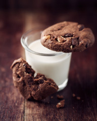 Glass of milk and chocolate cookies with nuts