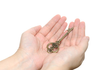 Two hands holding an old key