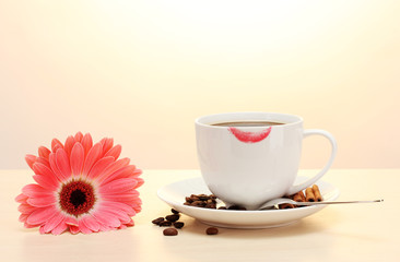 Fototapeta na wymiar cup of coffee with lipstick mark and gerbera beans, cinnamon