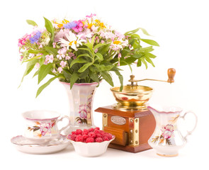 elegant teacups, raspberry, coffee grinder and flowers