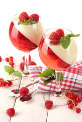 fruit jelly with berries in glasses on wooden table