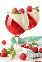 fruit jelly with berries in glasses on wooden table