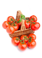 Wicker basket full of delicious tomatoes