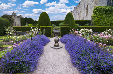beds of lavender leading to sundial and formal hedges - Powered by Adobe