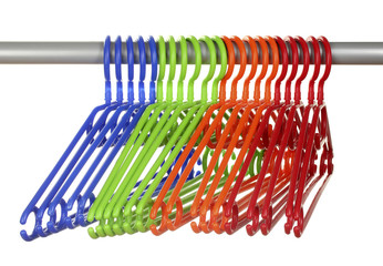 plastic hangers in row  isolated on white