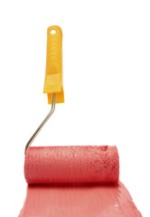 Obraz premium Paint roller with red paint isolated on white