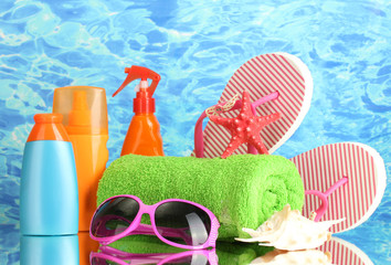 bright beach accessories, on blue sea background