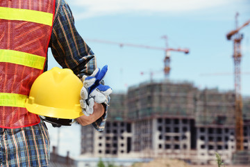 man holding yellow helmet