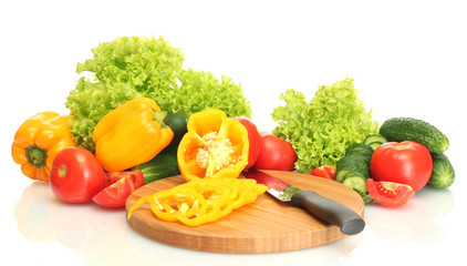 fresh vegetables and knife on cutting board isolated on white