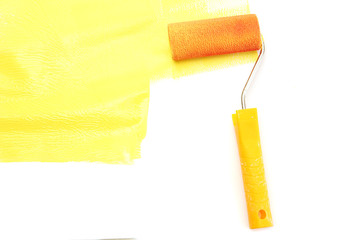 Obraz premium Paint roller with yellow paint isolated on white