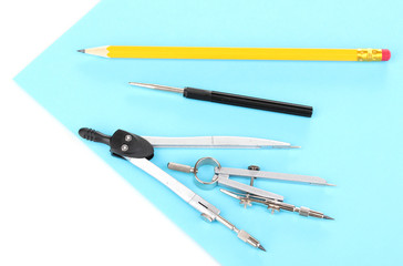 Drafting instruments on color paper isolated on white