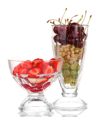 Mixed fruits and berries in glasses isolated on white