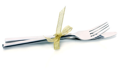 Silver fork and knife tied with ribbon isolated on white