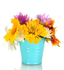 beautiful bouquet of bright  wildflowers in blue metal bucket,