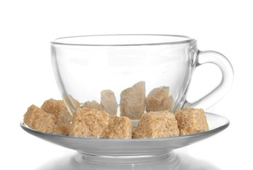 Lump brown cane sugar cubes in glass cup isolated on white