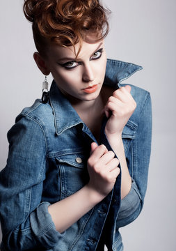 Unusual young glamorous woman in jeans jacket - bright make up