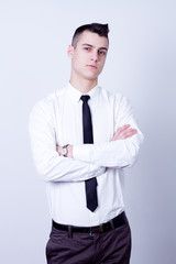 young handsome businessman in white shirt on gray background