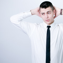 portrait of a young business man looking depressed from work