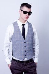 attractive business man wearing sunglasses in gray waistcoat