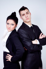 modern young business couple posing on gray background