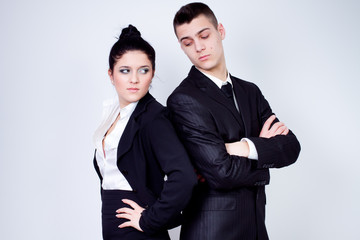 modern young business couple posing on gray background