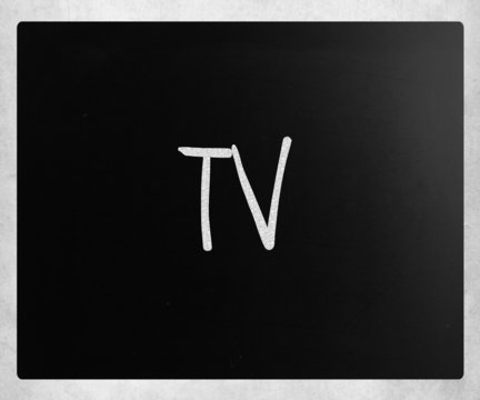 "TV" handwritten with white chalk on a blackboard