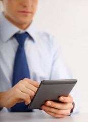 Handsome businessman using computer plane-table