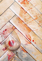 Broken wine glass on the old parquet