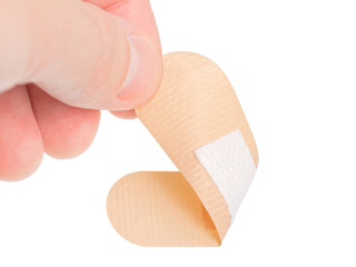 Adhesive bandage and hand on white background