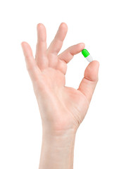 pill in hand on white background