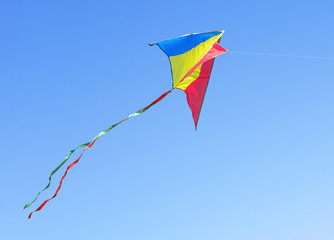 Kite against the blue sky. Symbol of dreams and happiness