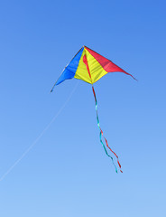 Kite against the blue sky. Symbol of dreams and happiness