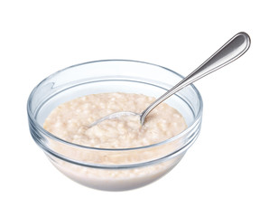 Oatmeal in a glass bowl on white background