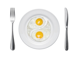 Fried eggs in the form of yin and yang on a plate.