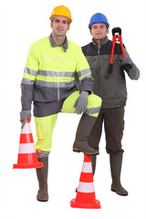 Two men stood with traffic cones