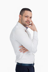 Man standing up while holding his chin with his hand