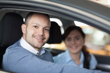 Happy man smiling in a car