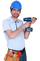 Construction worker holding a drill.