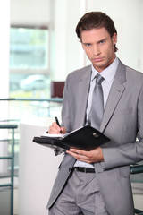 Fototapeta na wymiar Businessman holding diary