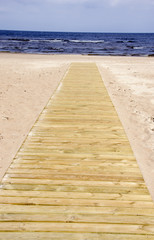 Fototapeta na wymiar wooden track on the beach and sea resort