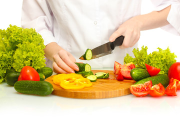 woman hands cutting vegetables on kitchen blackboard