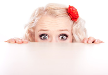 Funny girl hiding behind a table