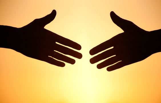 handshake at sunset