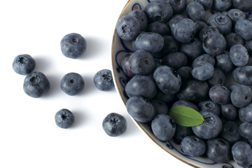 blueberries on porcelain plate isolated on white