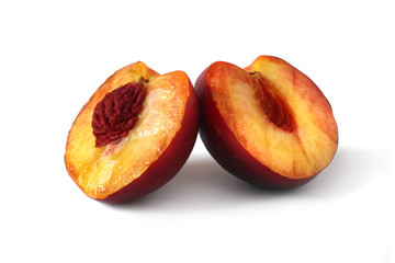 two halves of peach isolated on white
