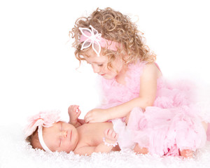 Toddler caring for her infant sister