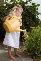 young girl watering flowers