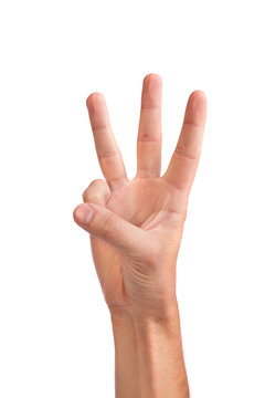 Three fingers being held in the air by a male hand