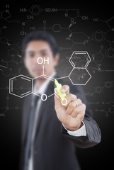 Fototapeta premium Teacher writing scientific formula on the whiteboard.