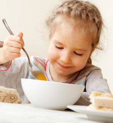 Little girl eating soup
